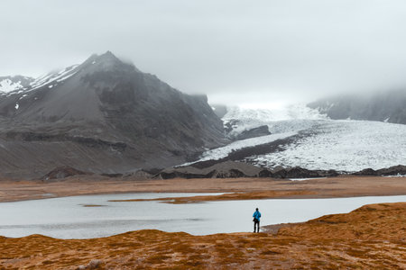 Lonely tourist near Vatnajokull glacial lagoon