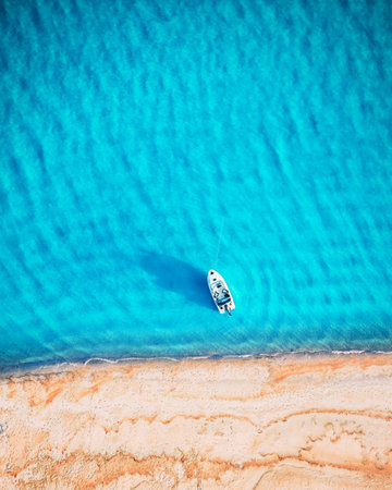 White yacht and turquoise water waves from top viewの写真素材