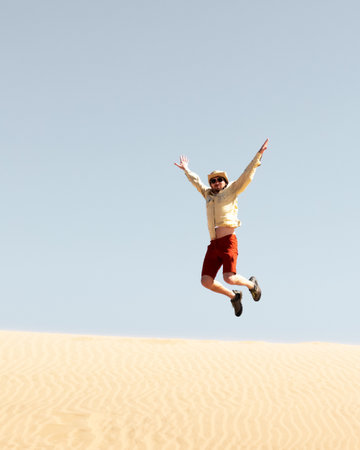 Single man throws sand in the Namib desertの写真素材