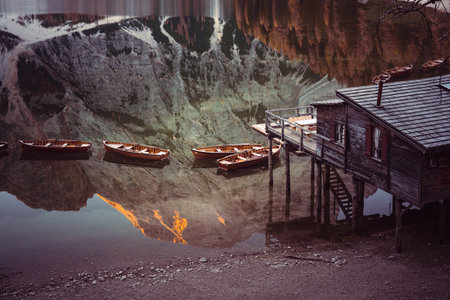 Wooden boats near old pier in clear waterの写真素材