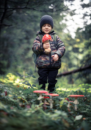 Small kid with Fly agaric mushroomの写真素材