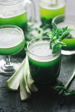 Celery fresh green juice in glass on wooden backgroundの写真素材