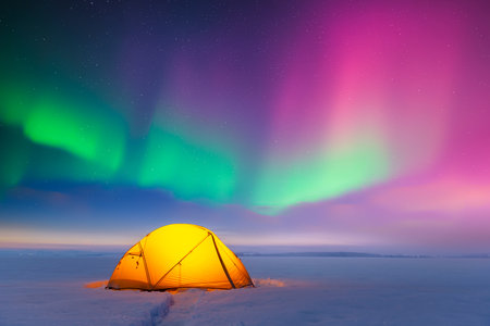 Yellow tent against the backdrop of incredible starry skyの写真素材
