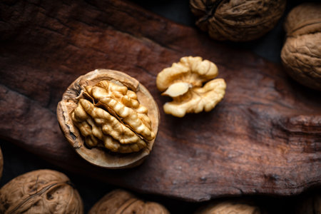 Cracked walnut with kernels on old wooden plankの写真素材