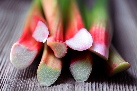 Close up of ripe rhubarb stalks on a wooden tableの写真素材