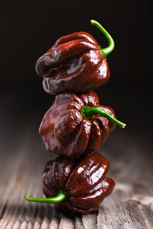 Three ripened chocolate habanero peppersの写真素材