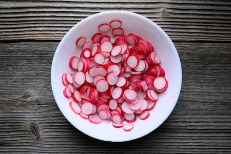 Thin radish slices served on a white plateの写真素材
