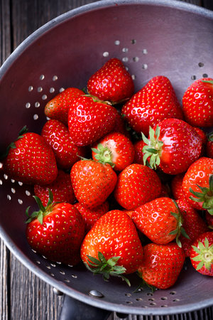 Just washed fresh ripe red strawberry in metal colander