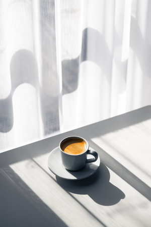 Aromatic espresso in a cup on a wooden tableの写真素材