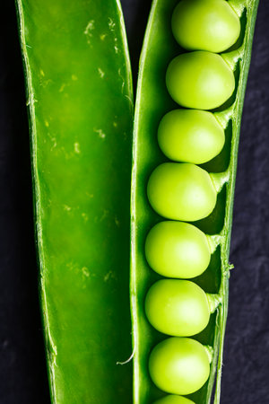 Macro shot of open green sugar snap pea pod