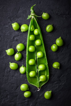 Open pod of green sugar snap pea with kernelsの写真素材