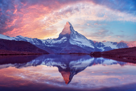 Stellisee lake glows at sunset with perfect Matterhorn reflectionの写真素材