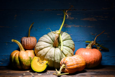 Rustic wooden table with assorted pumpkins formsの写真素材