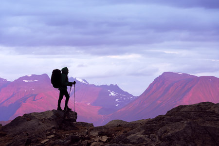 Backlit silhouette of a tourist with a backpack