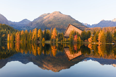 Strbske pleso shines in autumn light among High Tatras peaks in Slovakia