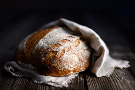 Close up of crusty leavened sourdough bread with a rough browned skin