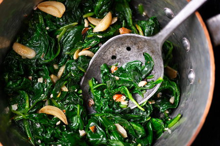 Warm sauteed spinach served in vintage copper potの写真素材