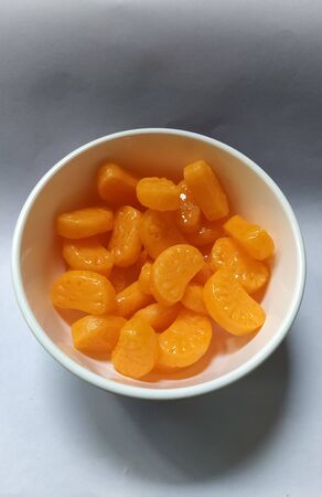 Sweet orange flavour candies in a small bowl.の写真素材