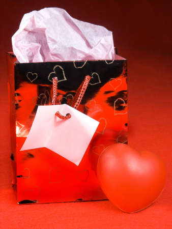 isolated over red felt gift bag and heartsの写真素材