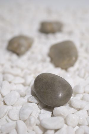 zen stones on white pebbles background - meditation concept