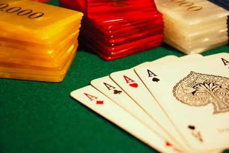 Cards and poker chips arranged on green felt