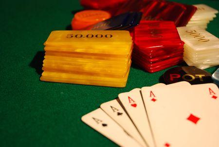 Cards and poker chips arranged on green felt