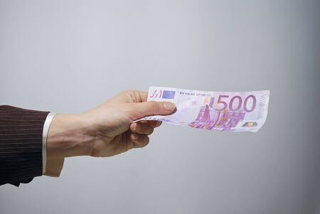 Money in hand - euro cash paymentの写真素材