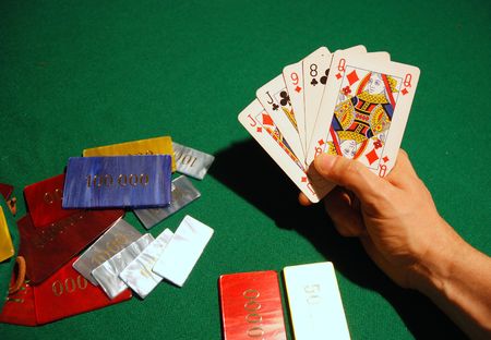 Cards and poker chips arranged on green felt