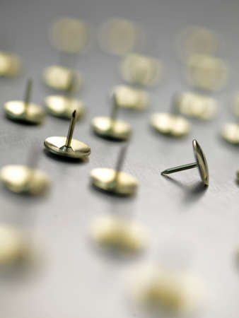 Drawing pins on metallic surfaceの写真素材