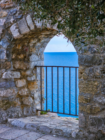 Old stone gate and blue sea on the island of Rhodes, Greeceの写真素材
