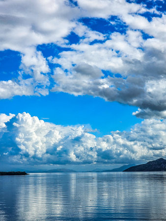 Blue sky with white clouds over sea. Beautiful summer seascape.の写真素材