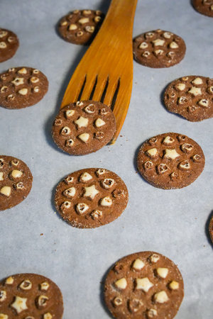 Close-up of cookies on baking tray with wooden spatula