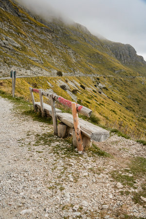 Two benches on foggy mountain ridge with distant peaksの写真素材