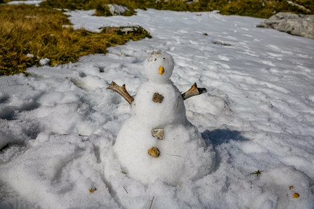 Snowman standing on fresh snow in winter landscapeの写真素材