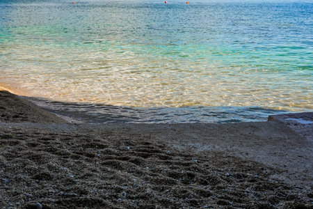 Sand and Clear Water Sea Shore Background and Textureの写真素材