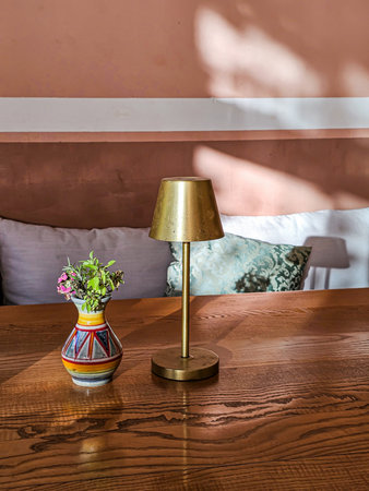 Close-up of table with lamp and vaseの写真素材