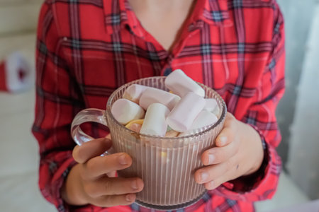 Close-Up of Hands Holding Mug of Cocoa with Marshmallowsの写真素材
