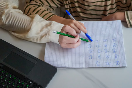 Close-Up of Hands Holding Pen and Notebook