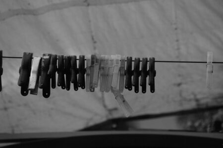 Clothespins hanging on a cable