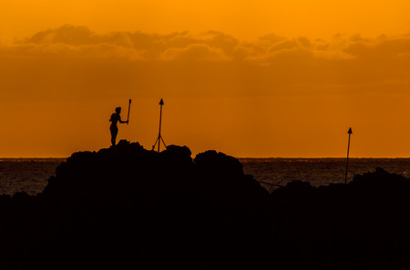 A cliff diver performs the torch lighting ceremony at Maui Blackrockの写真素材