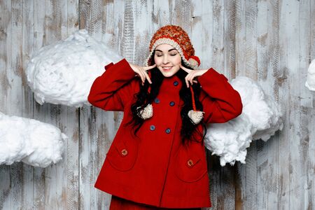 Pretty woman in red knitted warm hatの写真素材