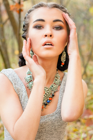 Young beautiful woman face with necklaceの写真素材