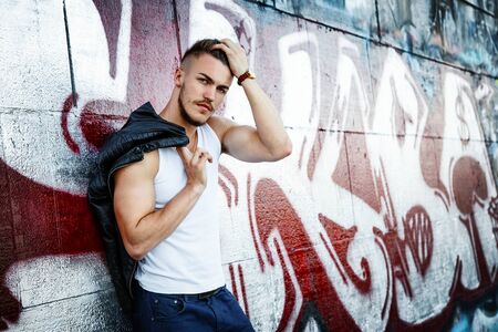 Attractive young man in white shirt outdoorsの写真素材