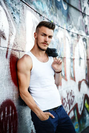 Attractive young man in white shirt outdoorsの写真素材
