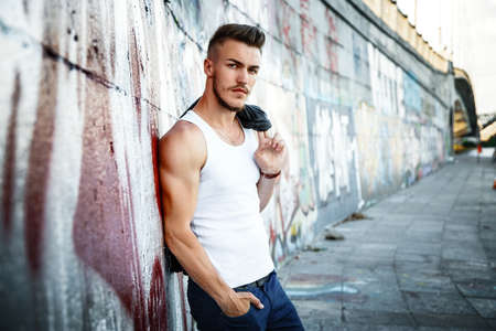 Attractive young man in white shirt outdoorsの写真素材