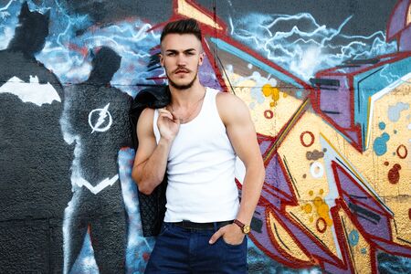 Attractive young man in white shirt outdoors