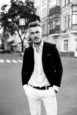 Handsome stylish man in elegant black jacket and white shirtの写真素材