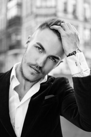 Portrait of handsome stylish man in elegant black jacket and white shirtの写真素材