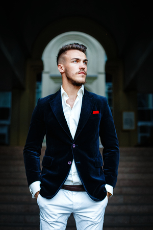 Handsome stylish man in elegant black jacket and white shirtの写真素材