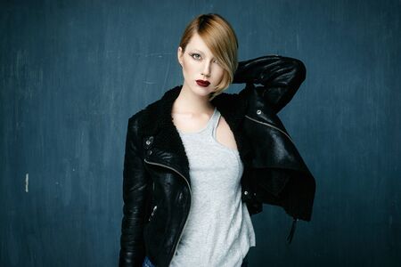 Beautiful woman in a leather jacket with bright makeupの写真素材